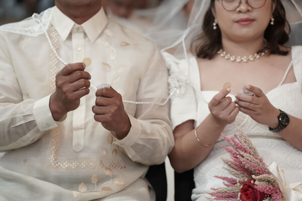 Newlywed couple sharing a sacred moment during the mass wedding ceremony